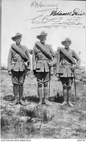Black and white photo of three officers in uniform.
