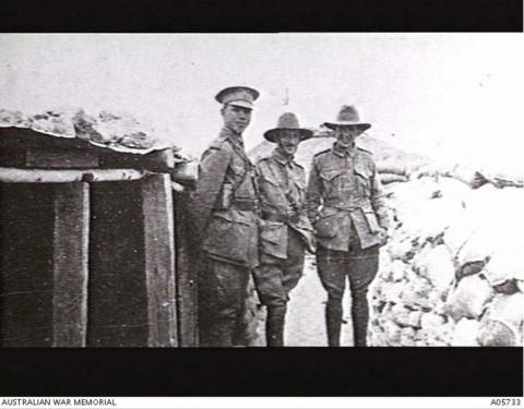 Black and white photo of three officers in uniform