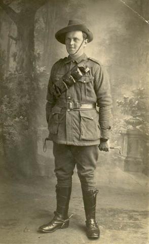 Sepia full body portrait of a soldier in uniform.