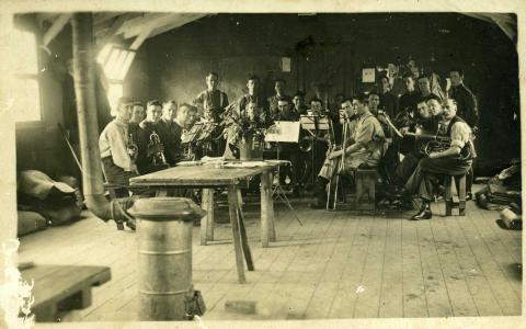 Sepia photograph of a group of men in uniform.