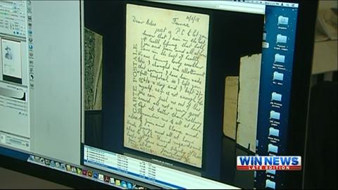 Screencap depicts a monitor showing a scan of a document. 