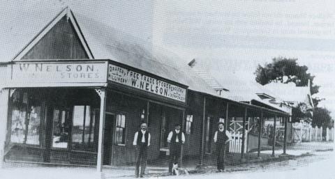 Black and white photo of a storefront.