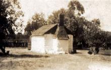 Sepia photograph of a small shack.