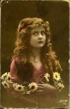 Postcard from Judy to Annie. Front depicts a portrait of a woman with flowers in her hair.