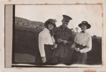 Photograph of man in uniform and two women on each side of him. 