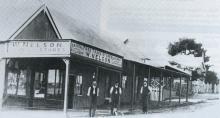 Black and white photo of a storefront.