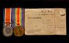 Picture of two war medals alongside it's envelope.